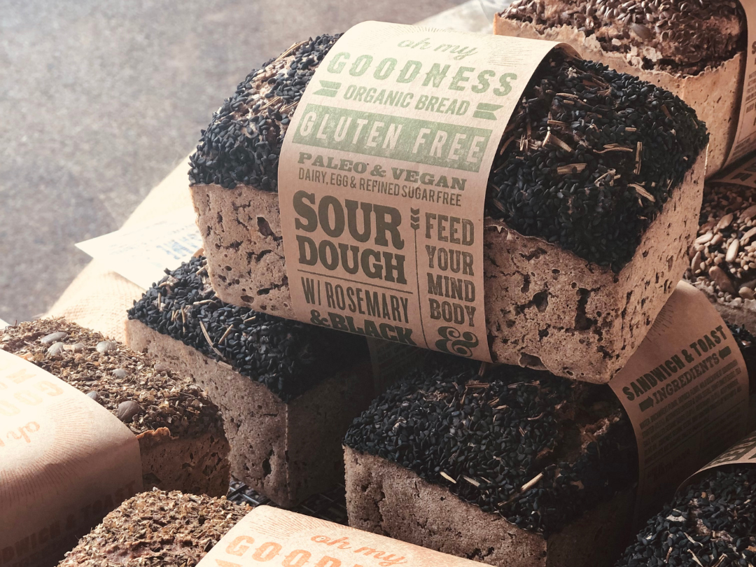 Wisefoods | OMGoodness organic gluten free Rosemary & Black Sesame loaves stacked on top of each other