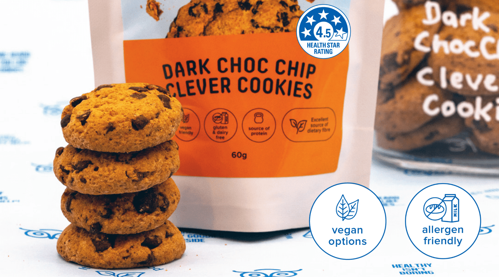 Wisefoods | A stack of 4.5 Heath Star-rated Vegan & Allergen friendly Dark Choc Chip Clever Cookies, alongside packaging and cookies in a jar 