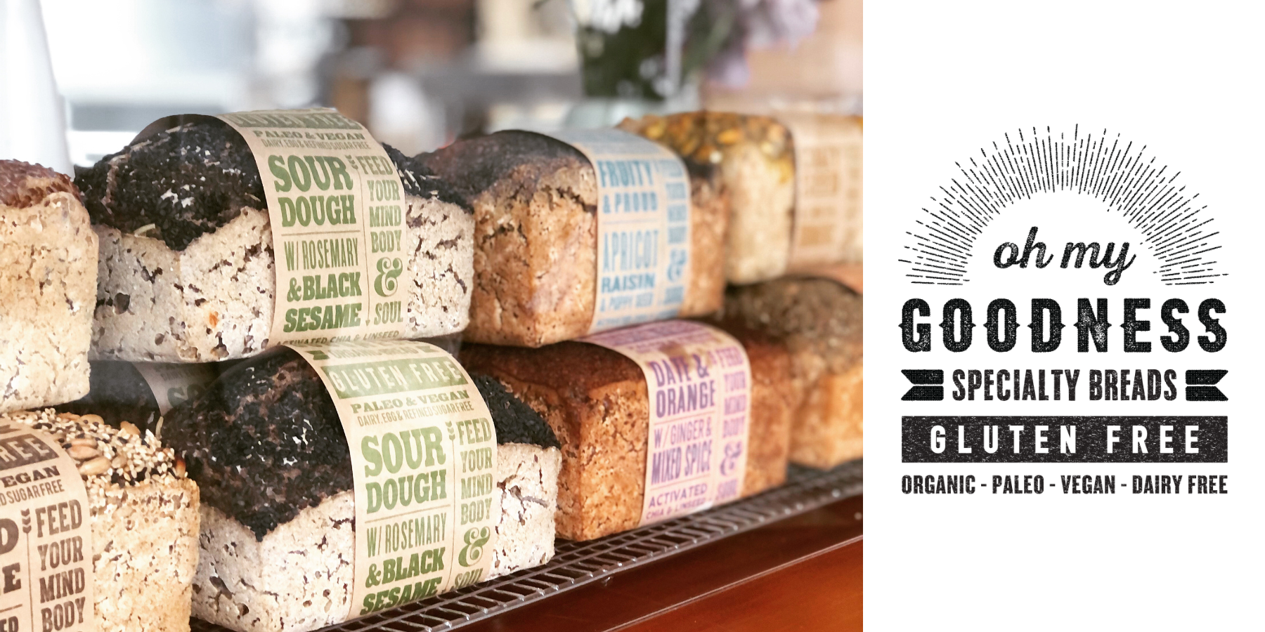 OMGoodness organic gluten free sourdough with rosemary & black sesame loaves displayed with other flavours of OMG bread to either side 