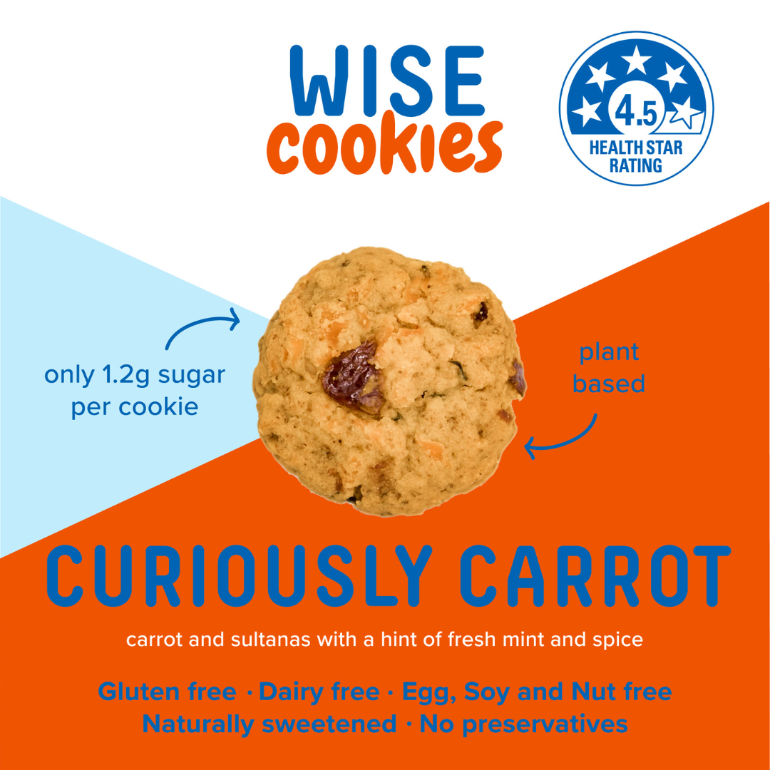 Wisefoods | 4.5 Health Star rated, allergy-friendly Curiously Carrot Wise Cookies in a glass jar with a stack of loose cookies and a hand holding one between thumb and forefinger to the right of the jar