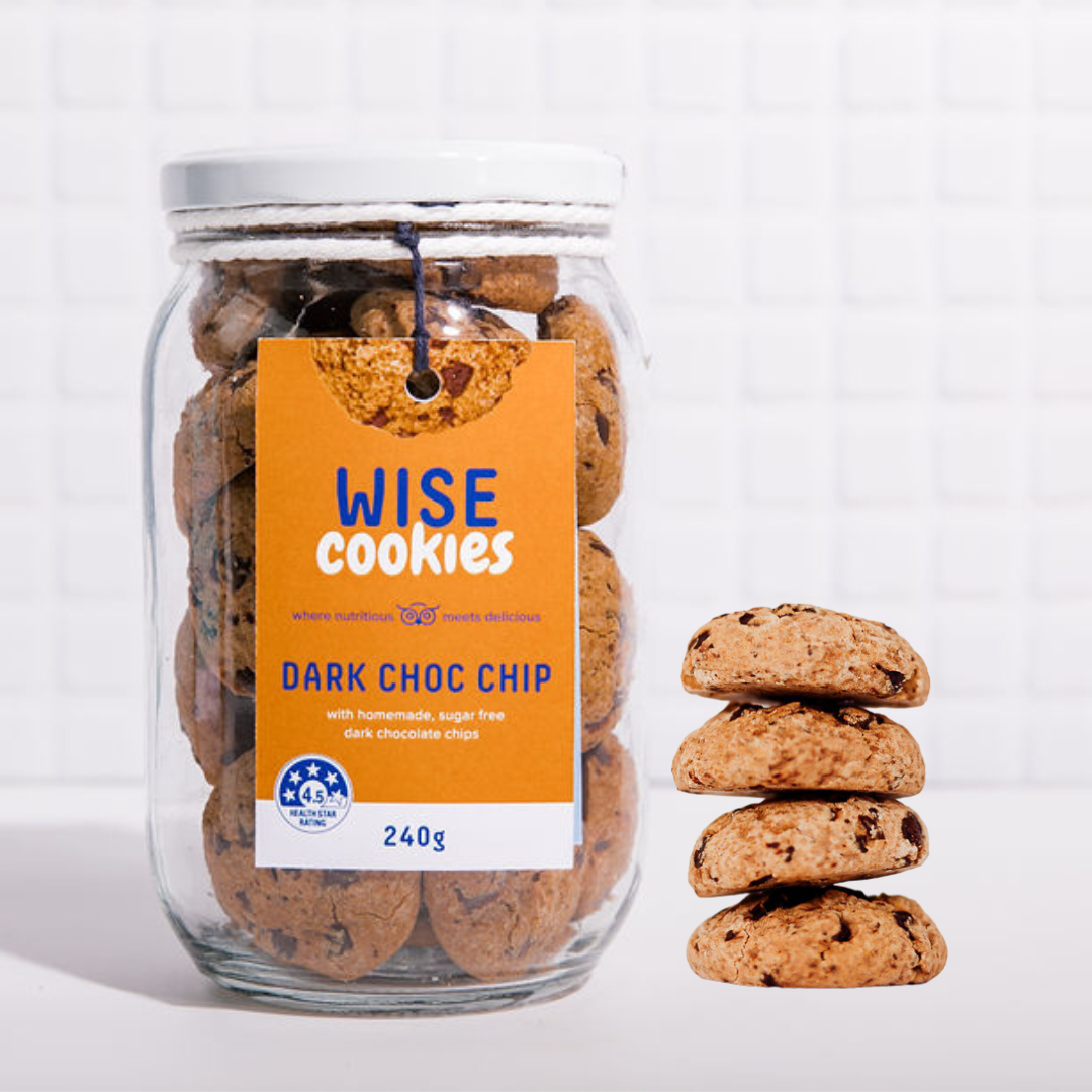 Wisefoods | 4.5 Health Star rated, allergy-friendly, plant based Dark Choc Chip Wise Cookies in a glass jar with a stack of loose cookies to the right in the foreground