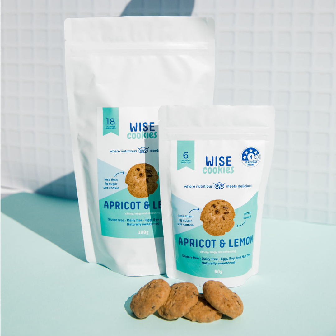 Wisefoods | Pantry Pack and Snack Pack of 4.0 Health Star rated, allergy-friendly, plant based Wise Cookies side-by-side on a teal and white background with loose cookies in the foreground
