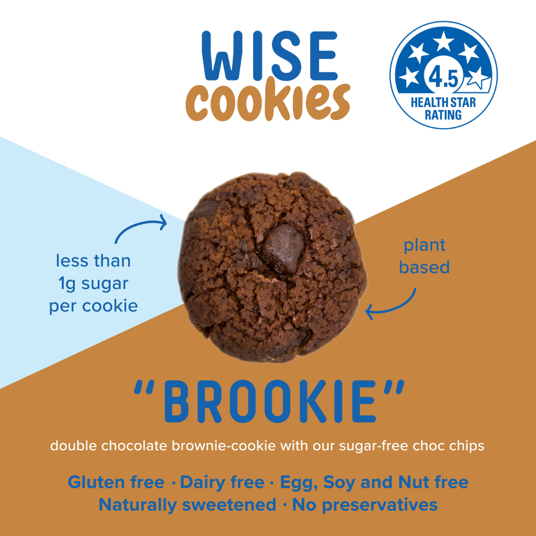 Wisefoods | 4.5 Health Star rated, allergy-friendly Double Choc "Brookie" Wise Cookies in a glass jar with a stack of loose cookies and a hand holding one between thumb and forefinger to the right of the jar